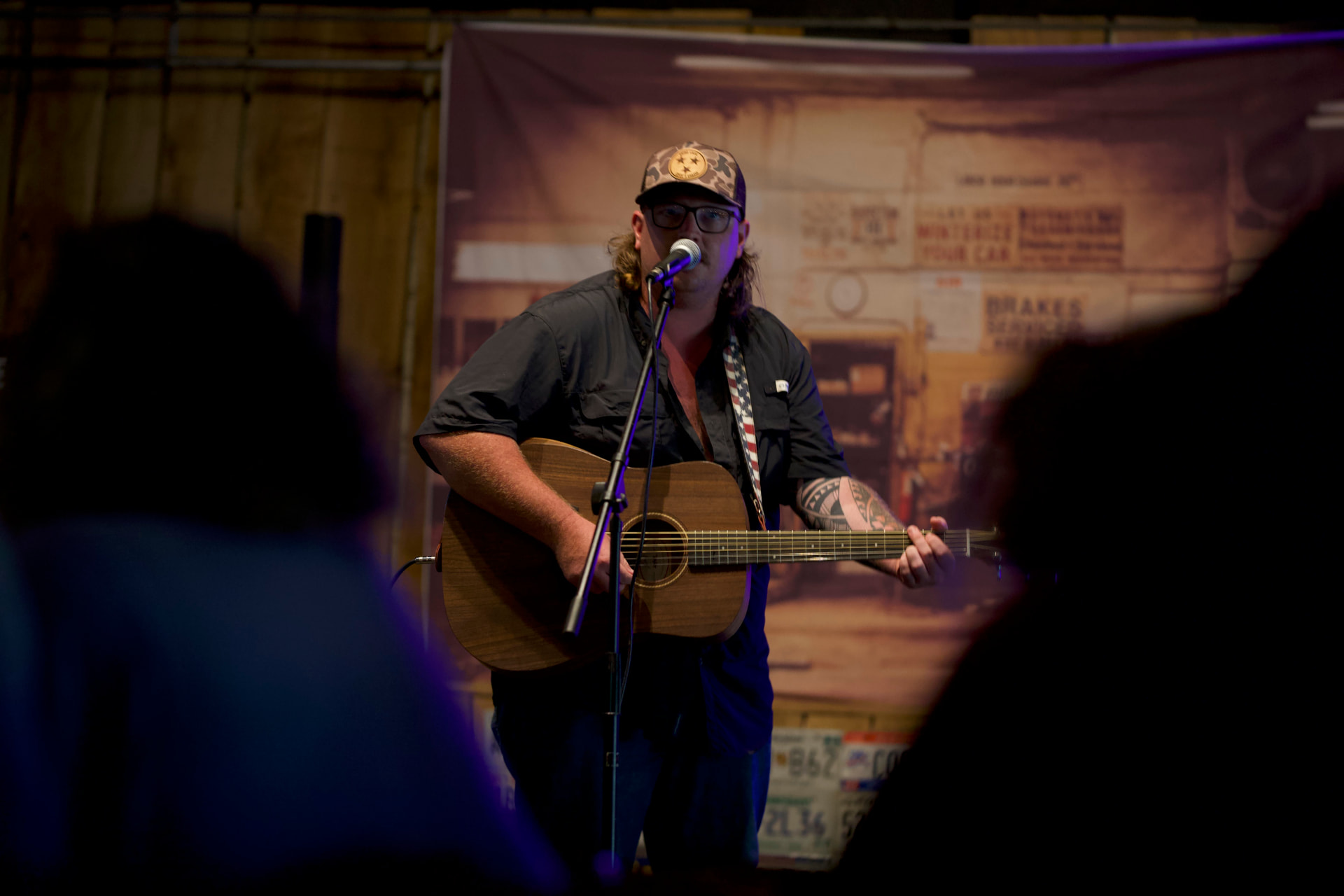 A musician performing with an acoustic guitar at a Roane County venue