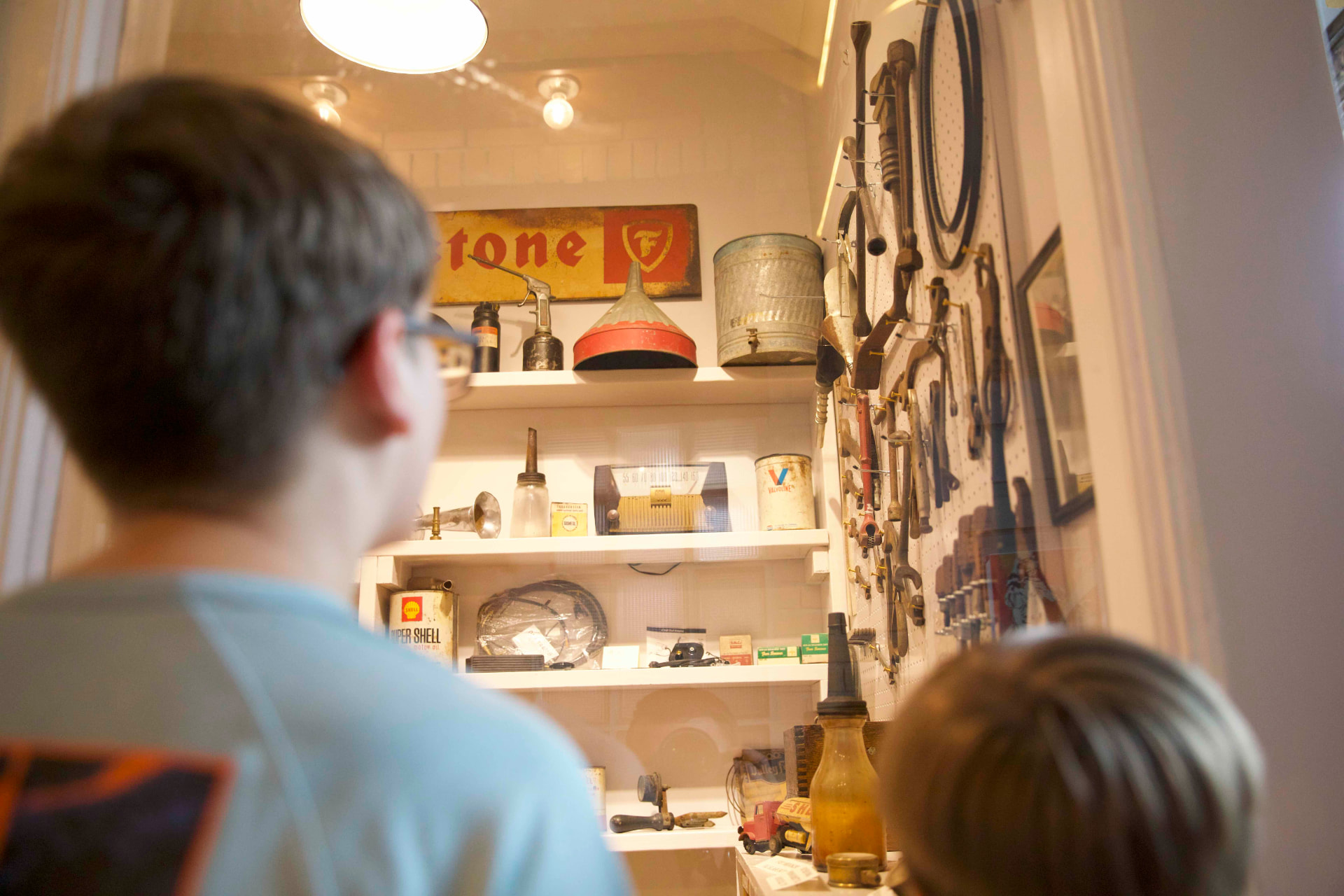 A child explores vintage tools and memorabilia in a local Roane County museum display