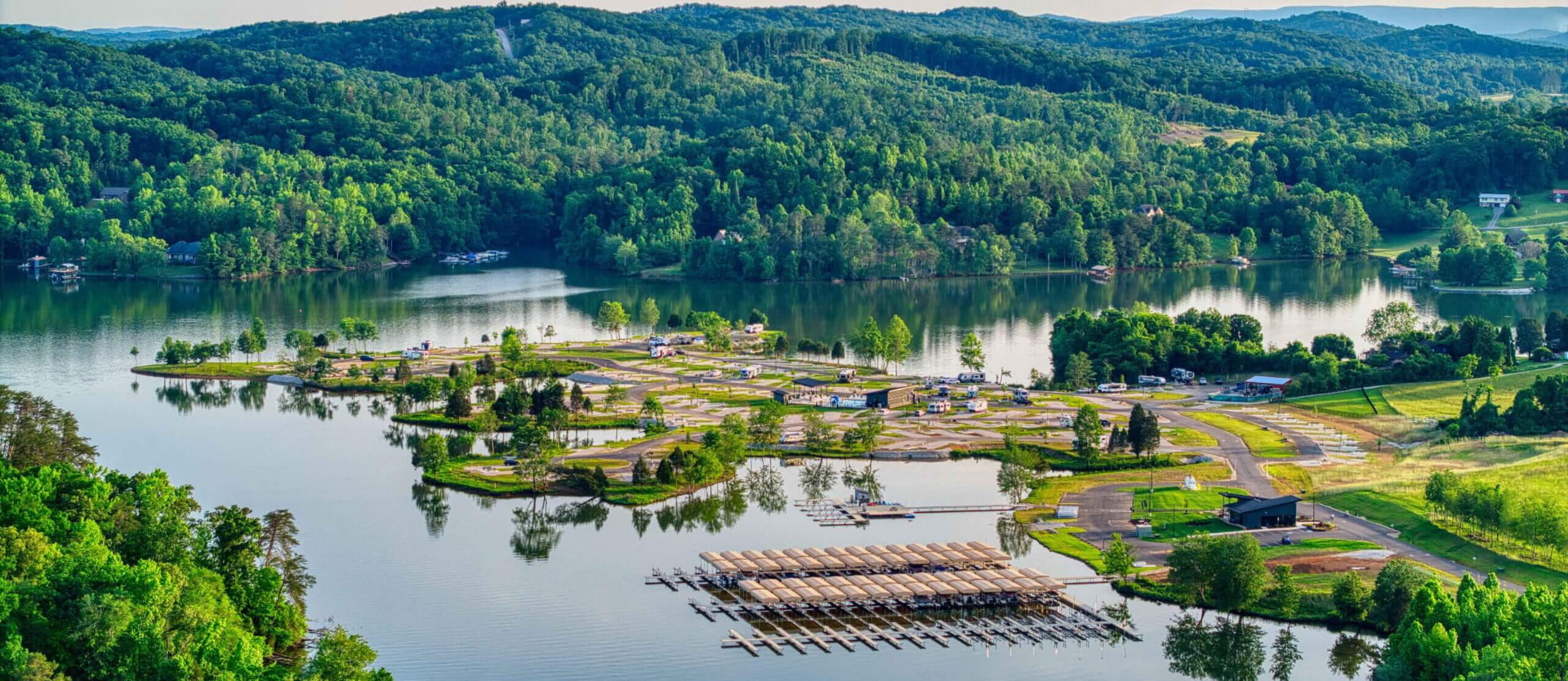 Aerial view of a Watts Bar Lake marina and campground surrounded by green hills