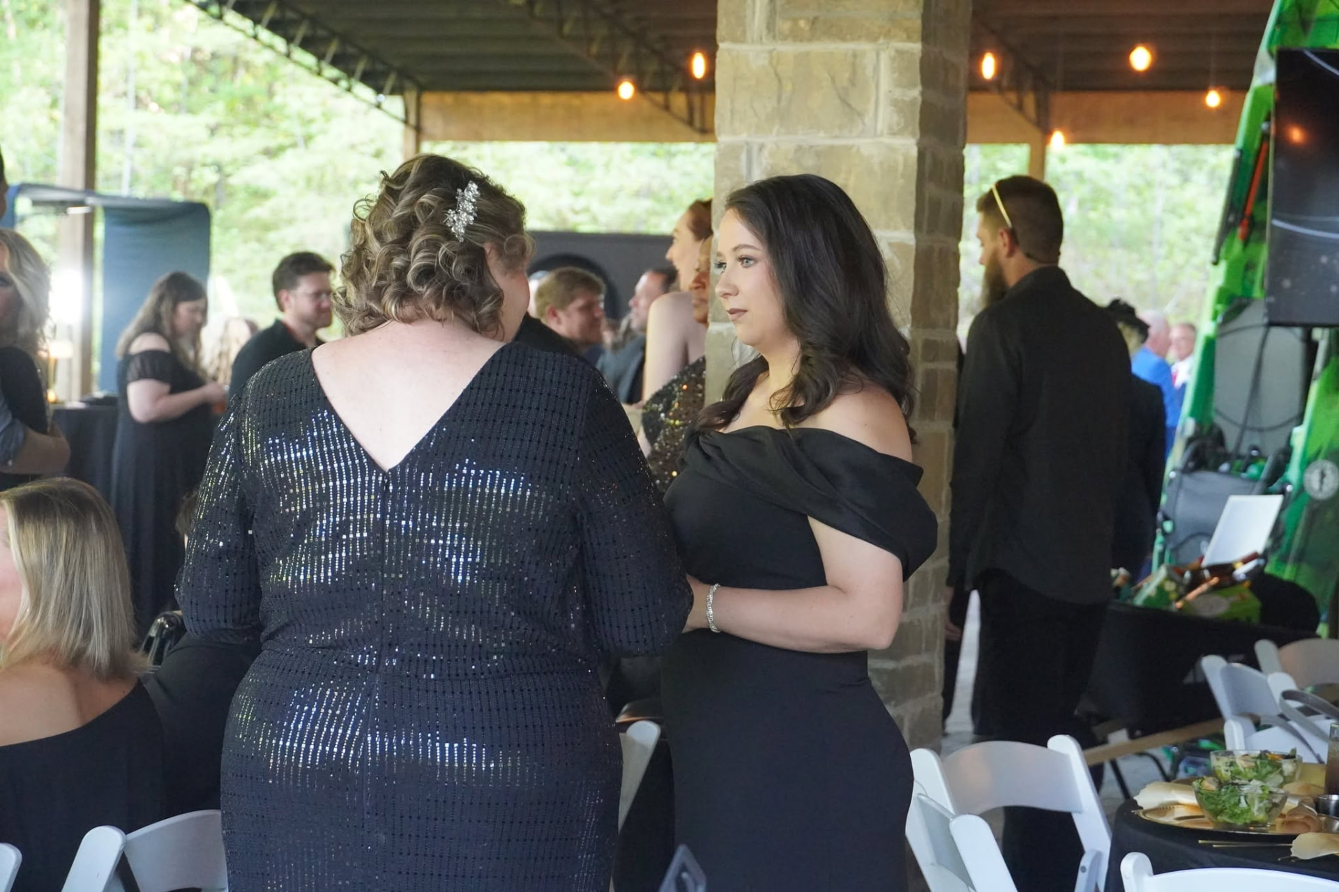 Guests mingling at a Roane Alliance outdoor awards celebration under a covered pavilion